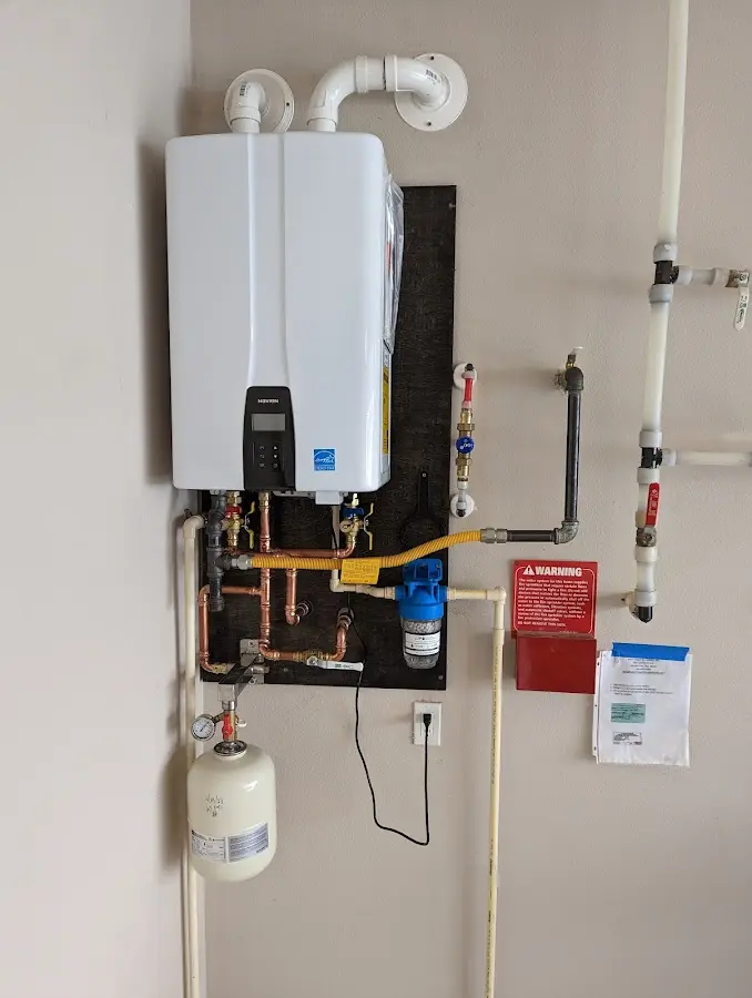 Professional plumber installing copper piping in a Lynchburg home